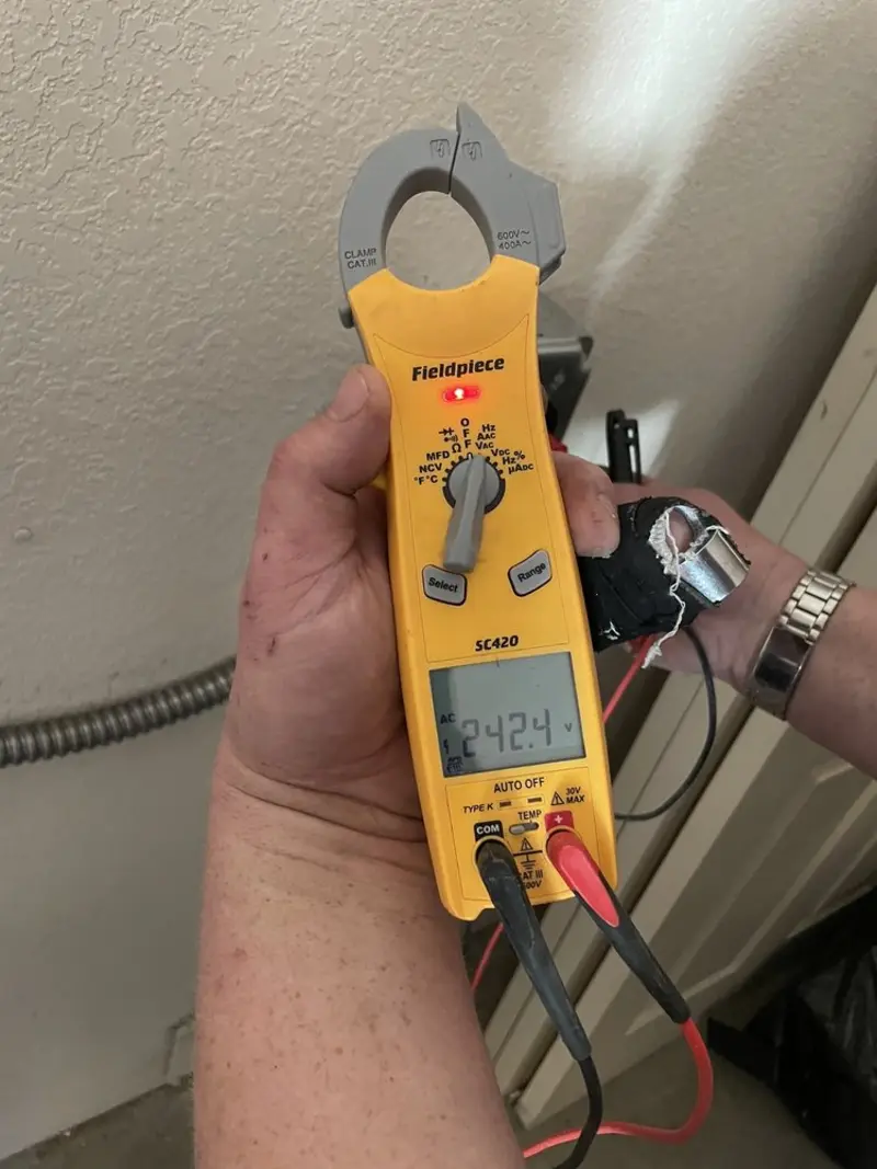 Voltage testing with clamp meter during Ceiling Fan Installation in New Albany